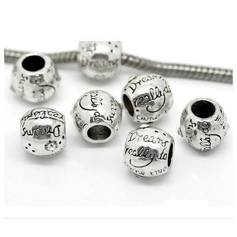 Seven Dreadz, Silver, Dreams Do Come True, Dreadlock Hair Beads with 5 millimetre hole through the middle, with one bead threaded with a silver spiral chain, shown against a white background