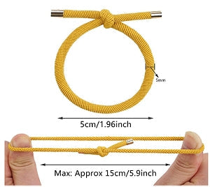 Two Yellow twisted rope-effect dreadlock hair ties, the upper shown unstretched (5 cm 1.96 in. width), and the lower shown stretched between two thumbs (15 cm 5.9 in. width), against a white background