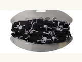 A Dreadz, Twelve in One Multi-Function Tubular Dreadlock Headband with a Black Skulls print, wrapped around its grey instruction board, shown against a white background