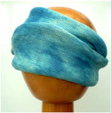 A Fair Trade Tie Dye Stretch Cotton Headwrap Dreadwrap in Aqua Blues colours shown on wooden mannequin head