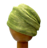 A Fair Trade Tie Dye Stretch Cotton Headwrap Dreadwrap in Green colours shown on wooden mannequin head