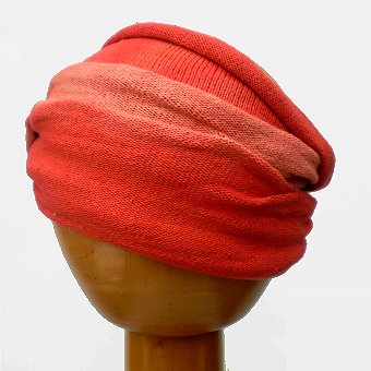 A Fair Trade Tie Dye Stretch Cotton Headwrap Dreadwrap in Orange colours shown on wooden mannequin head