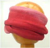A Fair Trade Tie Dye Stretch Cotton Dreadlock Headwrap/Dreadwrap in Pink and Red colours shown on wooden mannequin head