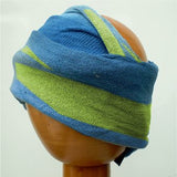 A Fair Trade Tie Dye Stretch Cotton Headwrap/Dreadwrap in Blue and Green colours shown on wodden mannequin head