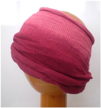 A Fair Trade Tie Dye Stretch Cotton Dreadlock Headwrap/Dreadwrap in Plum colours shown on wooden mannequin head