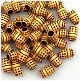 A collection of brown acrylic hearts hair beads for dreadlocks, with 6mm hole, shown grouped together on a white background