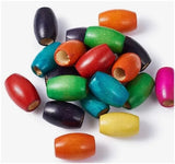 An assortment of large wooden oval dreadlock hair beads with a range of 9mm to 10mm inner holes in mixed colours - sold in 5 bead sets