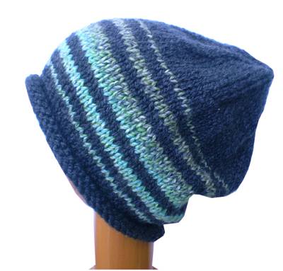 A Dreadz Hand Knitted Slouchy Rolled Brim Beanie Hat in Grey and Green colours on a wooden mannequin head