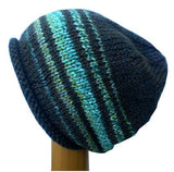 A Dreadz Hand Knitted Slouchy Rolled Brim Beanie Hat in Brown and Green colours on a wooden mannequin head