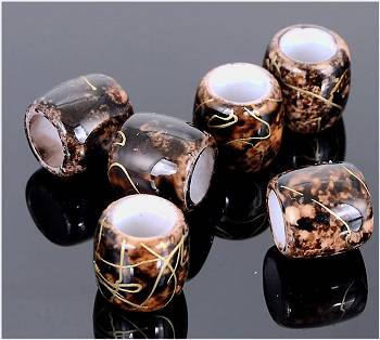 Dreadz Acrylic Black & Gold Splatter Barrel Hair Beads (7mm Hole) AL-753 x 3 Bead Pack - six individual beads displayed on a reflective black surface