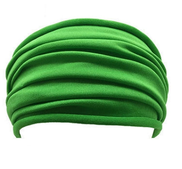 A Green, Lightweight, Stretch, Wide Headband shown displayed on white mannequin's head