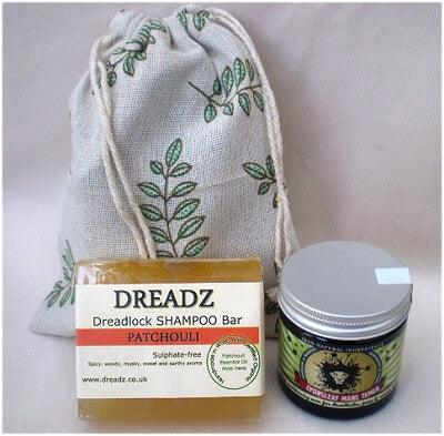Mane Tamer Dreadlock Wax and Dreadz Patchouli Dread Shampoo Bar DUO Pack Combo Kit (Style 3) shown against a sprig leaf printed drawstring bag
