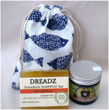 Mane Tamer Dreadlock Wax and Dreadz Patchouli Dread Shampoo Bar DUO Pack Combo Kit (Style 4) shown against blue fish printed drawstring bag