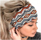 A Stretchy Cotton Wide Dreadlock Headband with Aztec style colours shown being worn by head model