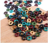 Picture of dozens of Wooden Earth Tones Hoop 6mm Hole Dreadlock Hair Beads displayed on wooden surface