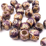 Multiple wooden patterned 7.4 millimetre hole brown paisley dreadlock hair beads displayed against white background