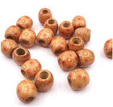 Several wooden patterned 7.4 millimetre hole sunset dreadlock hair beads displayed against white background