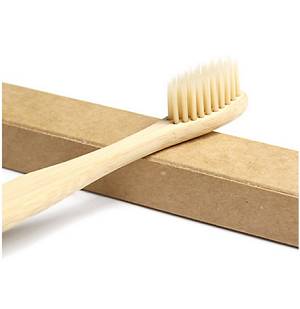 Head of Natural Eco-Friendly Biodegradable Bamboo Toothbrush with Medium Stiffness Bristles resting on box