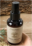 A 100 millilitre bottle of RAW ROOTs Dreadlock Creeps Tincture, used for Head Lice, displayed in a mother nature setting